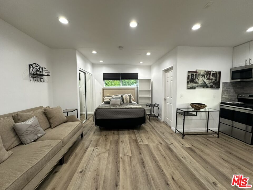 19542 Hart Street Reseda, CA 91335 - Photo 3 of 6 a living room with furniture and a wooden floor