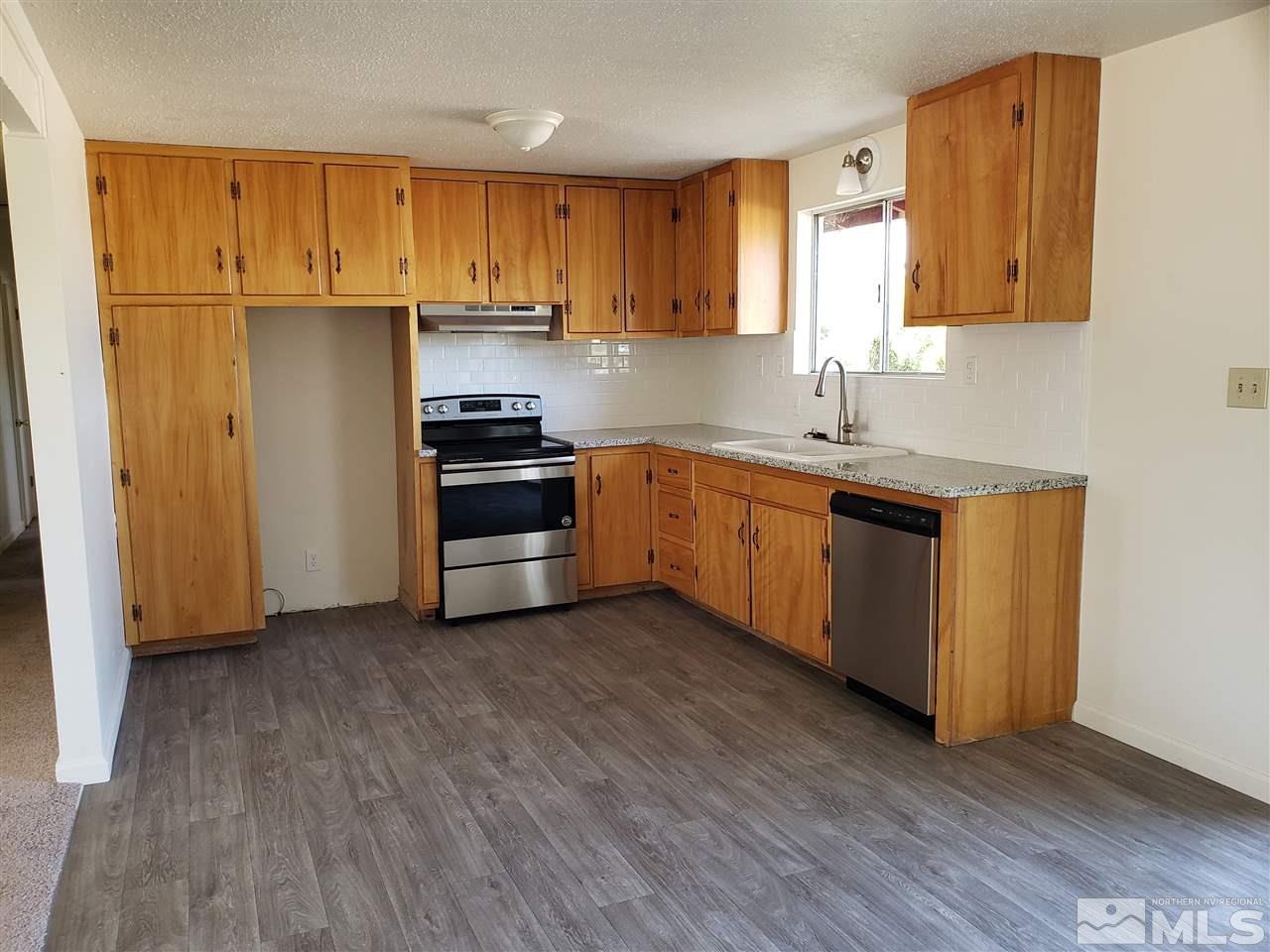 2355 Rice Road Fallon, NV 89406 - Photo 7 of 22 a kitchen with wooden floors and stainless steel appliances