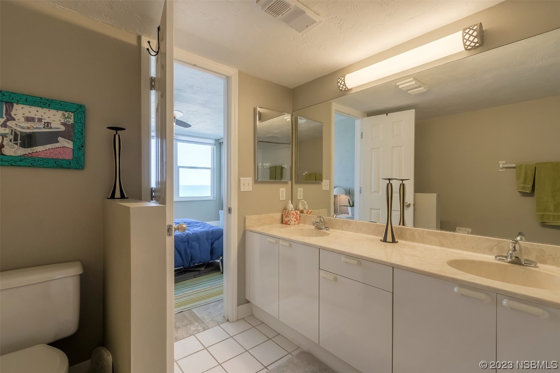 4545 South Atlantic Avenue, Unit 3204 Ponce Inlet, FL 32127 - Photo 22 of 58 a bathroom with a double vanity sink toilet and a tub
