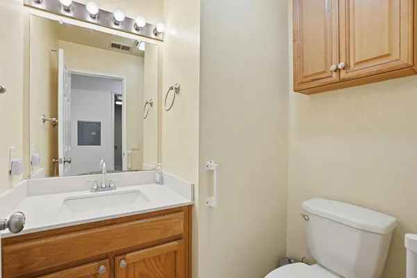 a bathroom with a sink a toilet and mirror