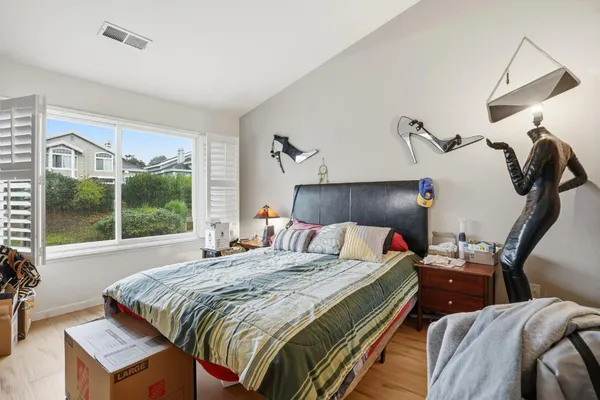 a bedroom with a bed and a window