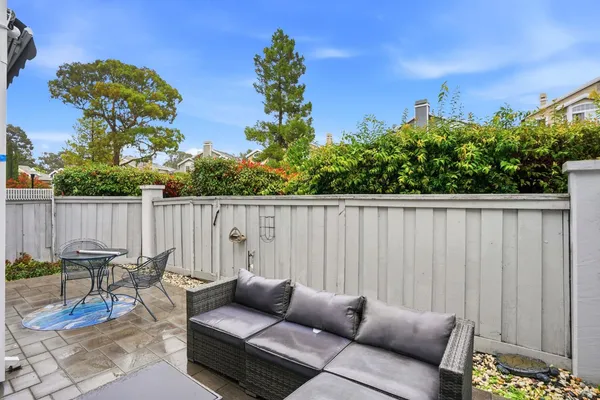 a backyard of a house with table and chairs