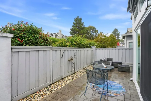 a backyard of a house with table and chairs
