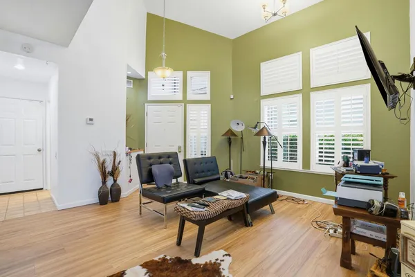 a living room with furniture and a wooden floor