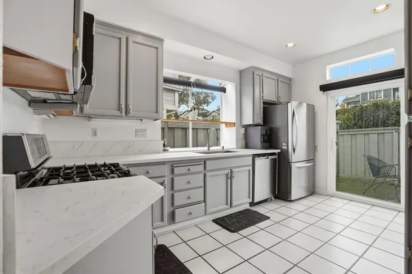 a kitchen with a refrigerator sink and stove