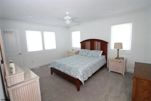 a bathroom with a sink a toilet a mirror and shower