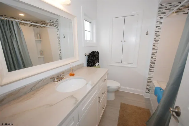 a living room with a flat screen tv and washer