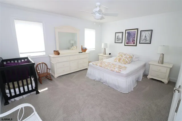 a bedroom with a bed chair and window