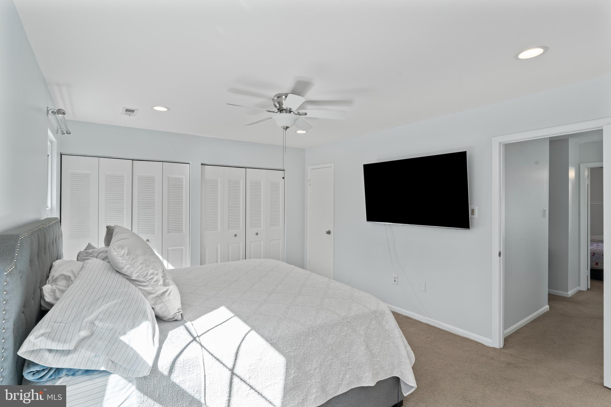 10267 Green Holly Terrace Silver Spring, MD 20902 - Photo 20 of 52 a bedroom with a bed and a flat screen tv