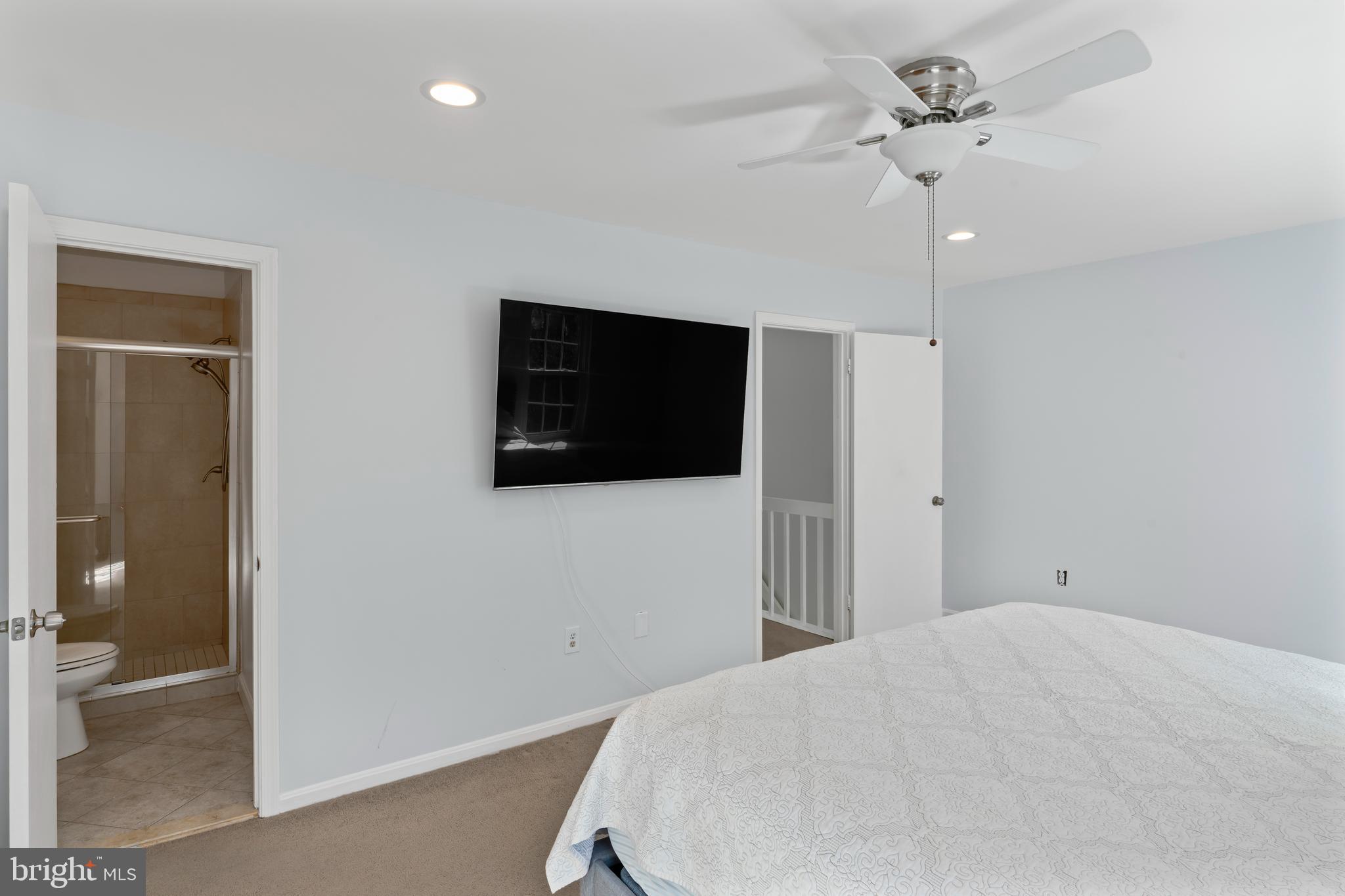 10267 Green Holly Terrace Silver Spring, MD 20902 - Photo 21 of 52 a bedroom with a bed and a flat screen tv