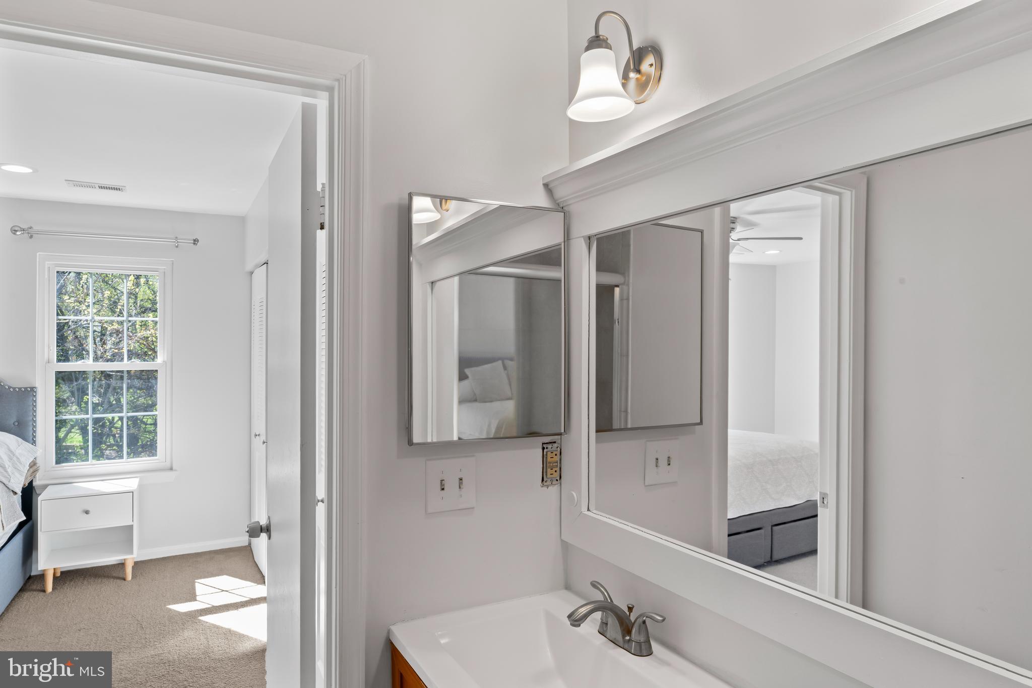 10267 Green Holly Terrace Silver Spring, MD 20902 - Photo 23 of 52 a bathroom with a double vanity sink mirror and bathtub