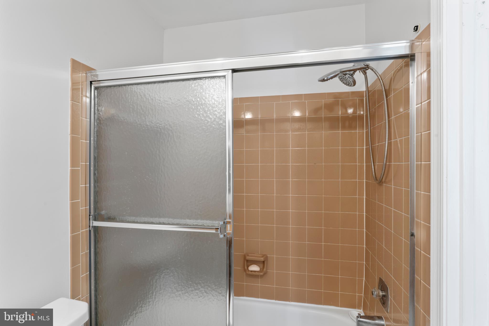 10267 Green Holly Terrace Silver Spring, MD 20902 - Photo 29 of 52 a bathroom with a glass shower door