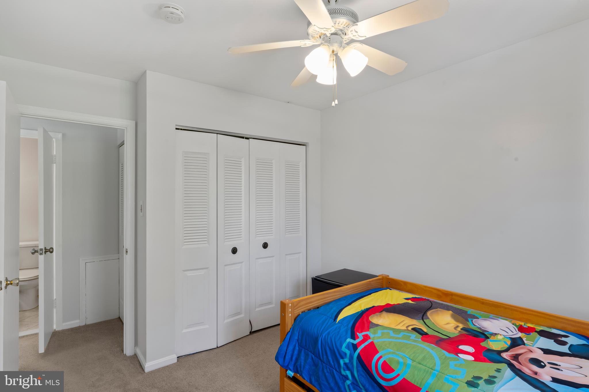 10267 Green Holly Terrace Silver Spring, MD 20902 - Photo 31 of 52 a bedroom with a bed and a chandelier