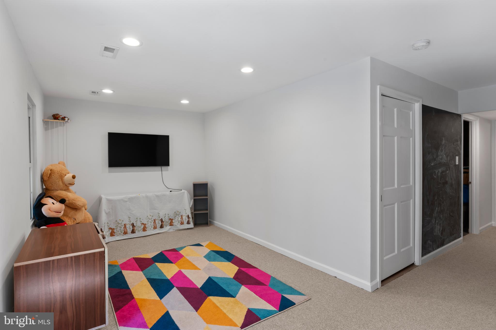 10267 Green Holly Terrace Silver Spring, MD 20902 - Photo 35 of 52 a living room with furniture and a flat screen tv