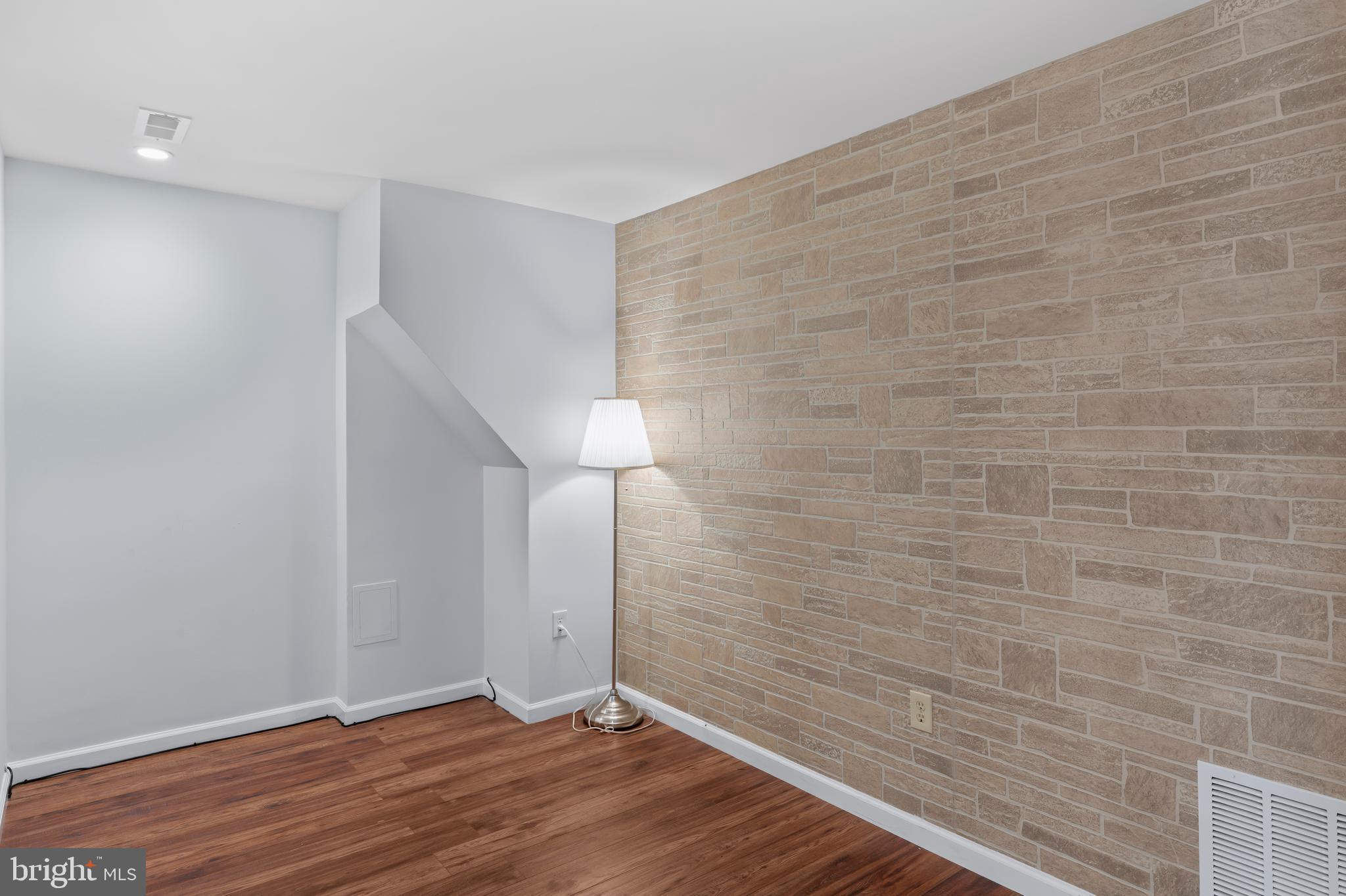10267 Green Holly Terrace Silver Spring, MD 20902 - Photo 36 of 52 a view of an empty room with wooden floor