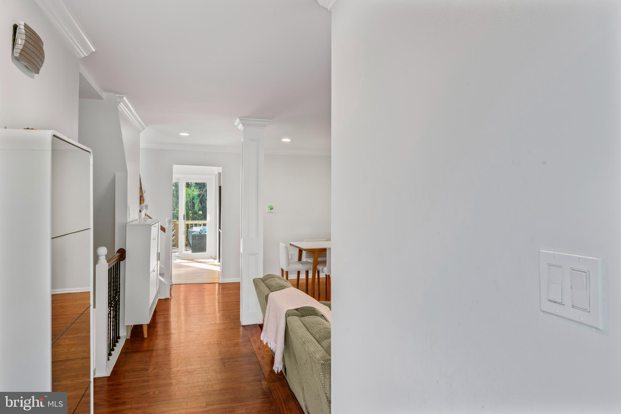 10267 Green Holly Terrace Silver Spring, MD 20902 - Photo 4 of 52 a view of a hallway with wooden floor and furniture
