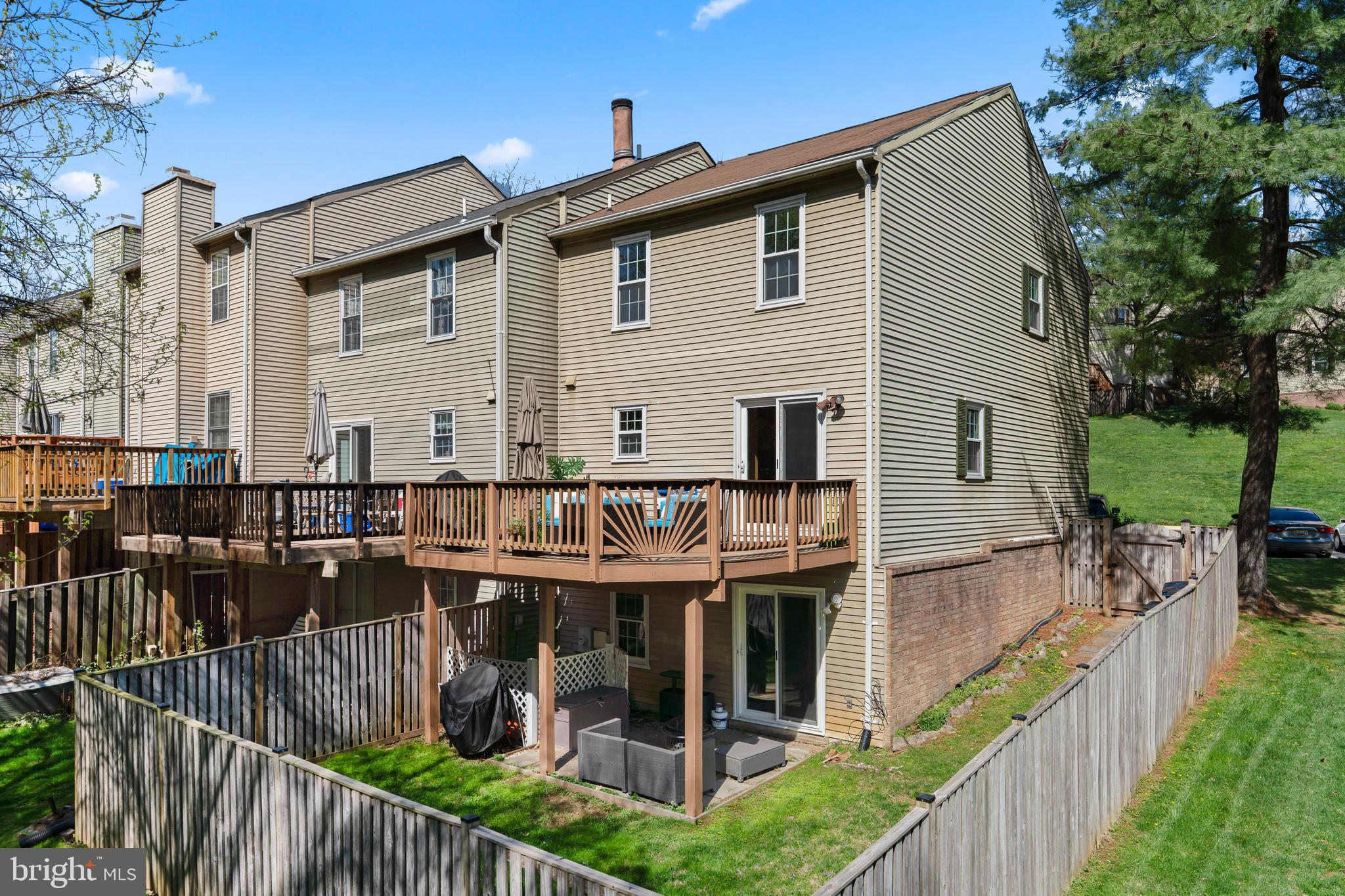 10267 Green Holly Terrace Silver Spring, MD 20902 - Photo 41 of 52 a view of a house with wooden deck and furniture