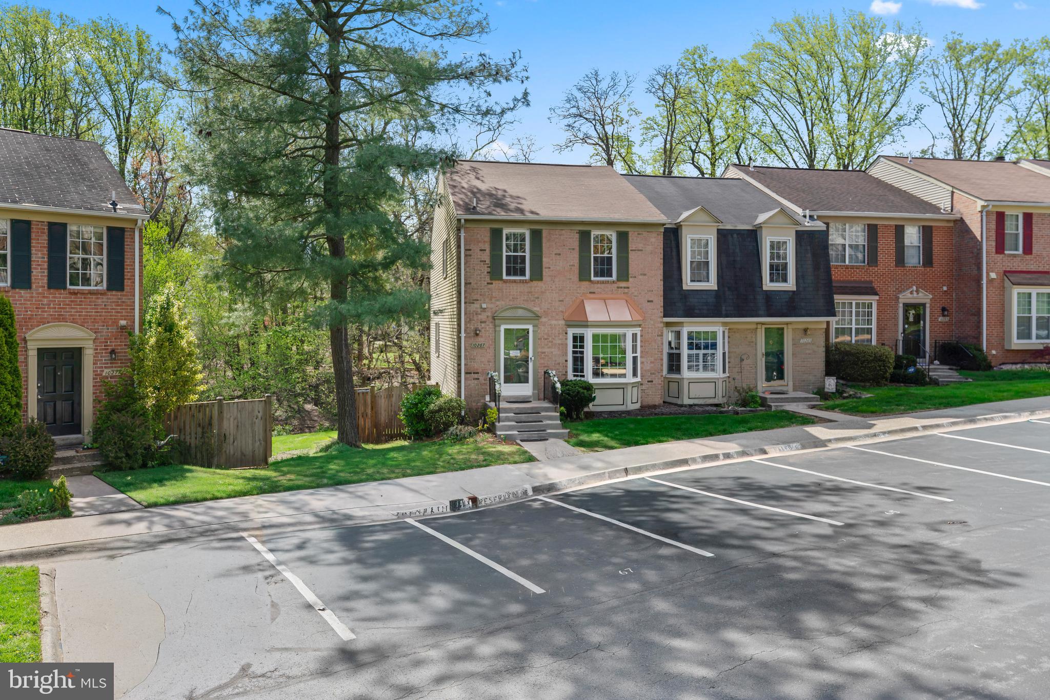 10267 Green Holly Terrace Silver Spring, MD 20902 - Photo 48 of 52 a front view of a house with a yard and a garage