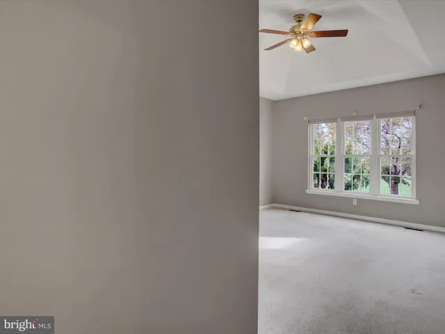 a bathroom with a window and a shower