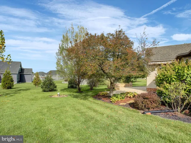 a view of a house with a yard and sitting area