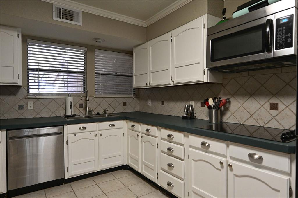 32 Rue Maison Abilene, TX 79605 - Photo 9 of 40 a kitchen with granite countertop white cabinets stainless steel appliances and sink