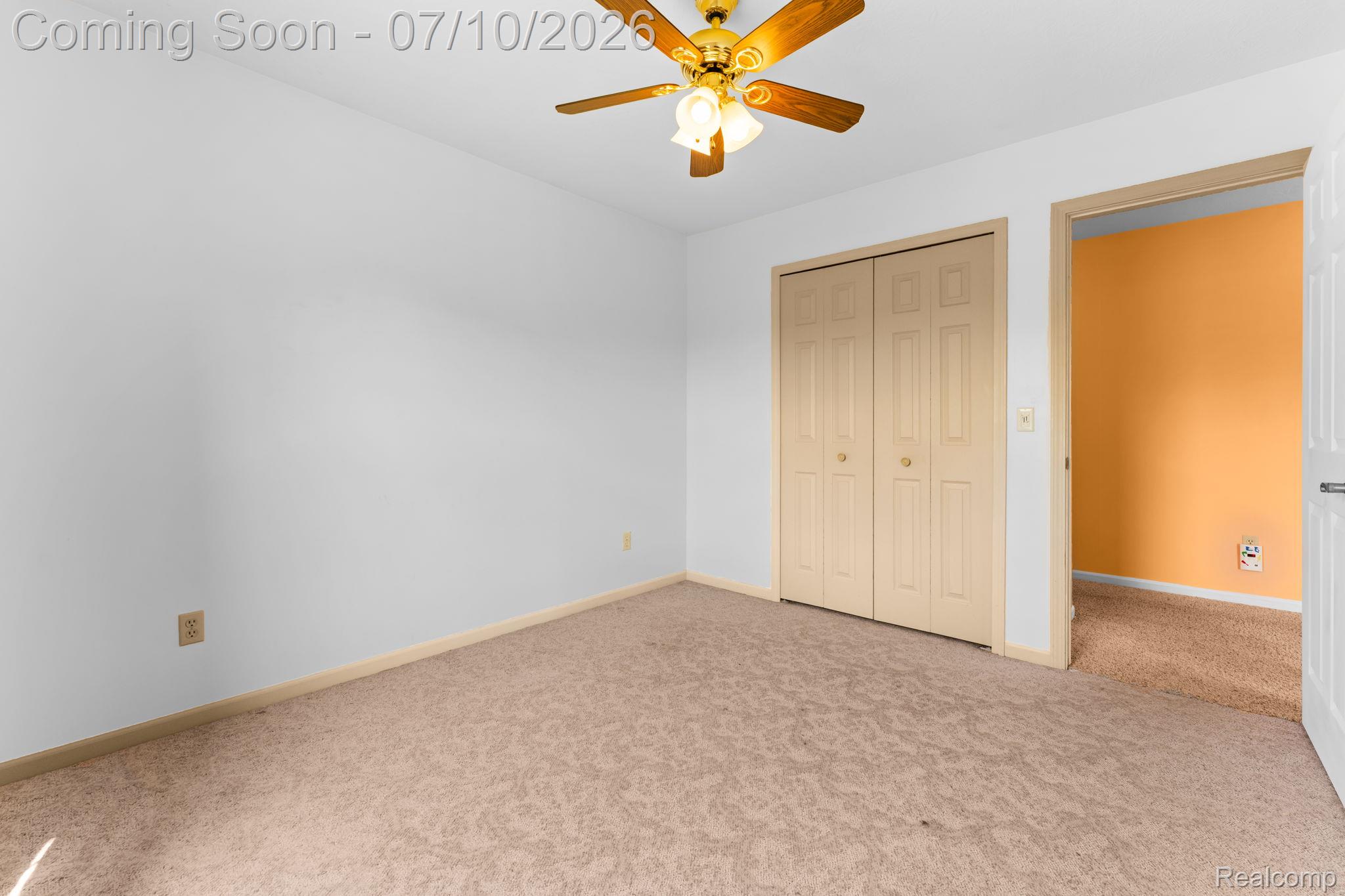 3144 North Nicholson Road Fowlerville, MI 48836 - Photo 45 of 70 Room featuring neutral wall tones, patterned carpeting, a bi-fold closet, and a ceiling fan with integrated lighting