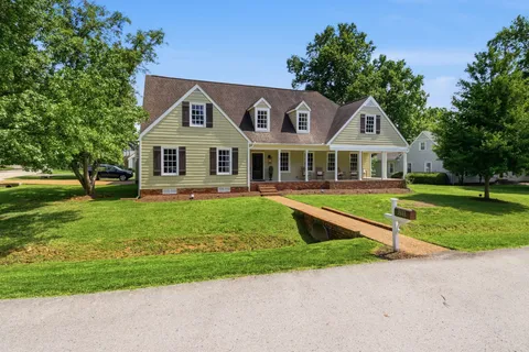 a front view of a house with a yard table and chairs