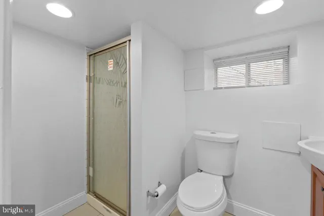 a white toilet sitting next to a bathroom sink
