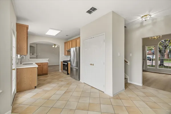 a large white kitchen with cabinets