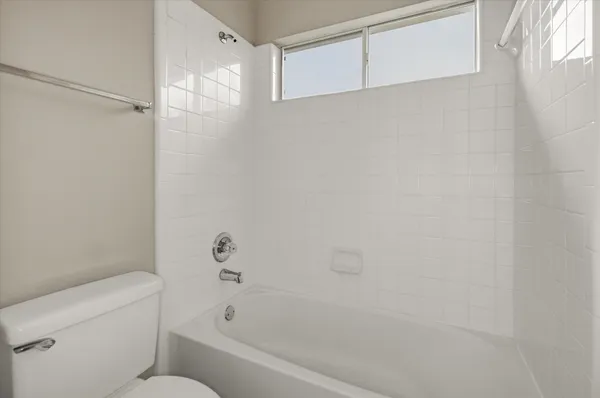 a bathroom with a bathtub and a toilet