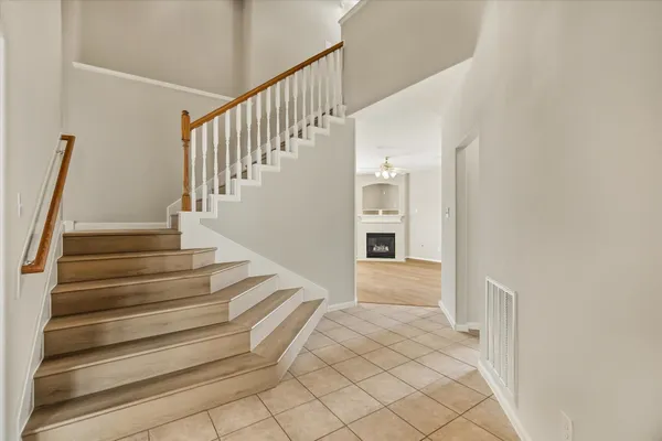 a view of entryway and hall with wooden floor