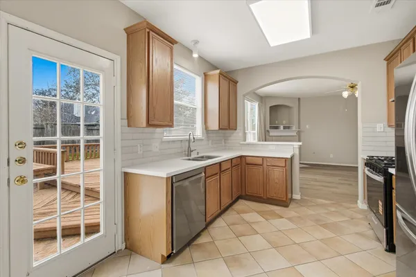 a large bathroom with a granite countertop sink a toilet a mirror and shower