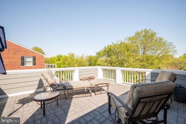 a view of a chair and tables in the balcony