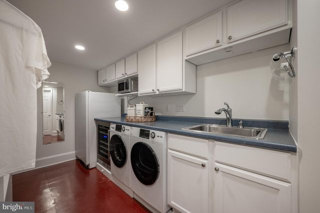 a kitchen with stainless steel appliances granite countertop a sink a stove and cabinets