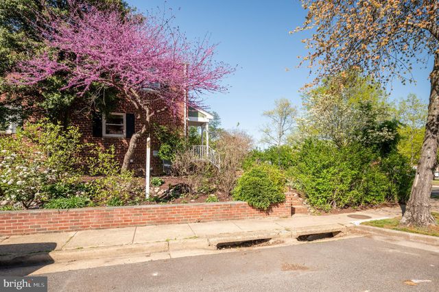 a front view of a house with a yard and fountain