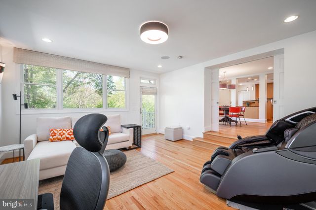 a bedroom with furniture and a large window
