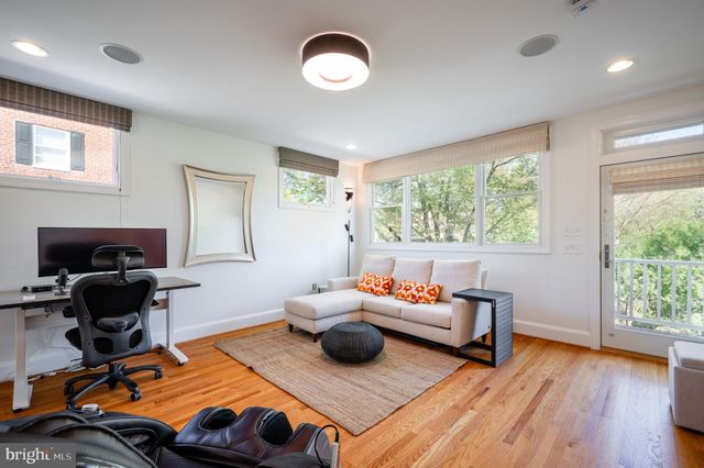a bedroom with furniture and a wooden floor