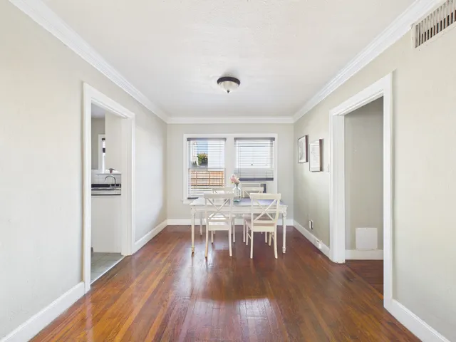 a view of a dining room with furniture and wooden floor