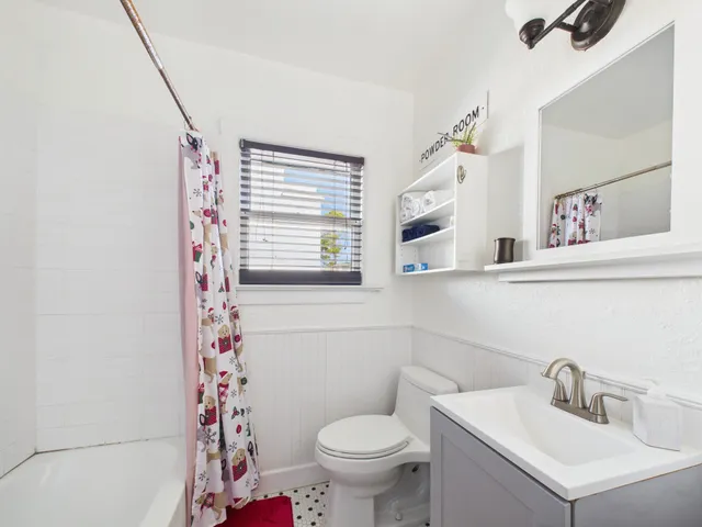 a bathroom with a toilet sink and mirror