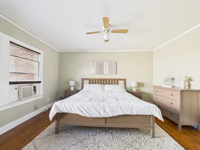 a bedroom with a large bed and a window