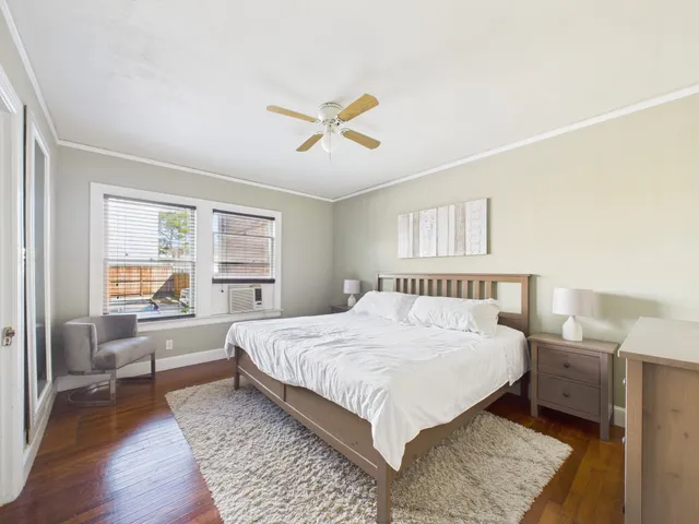 a bedroom with a large bed and a window