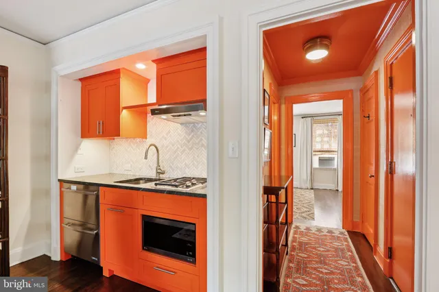 a hallway with sliding door and front door