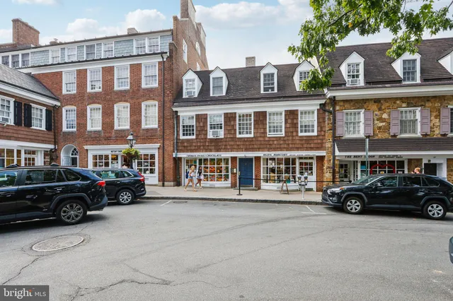 a car parked in front of a big house