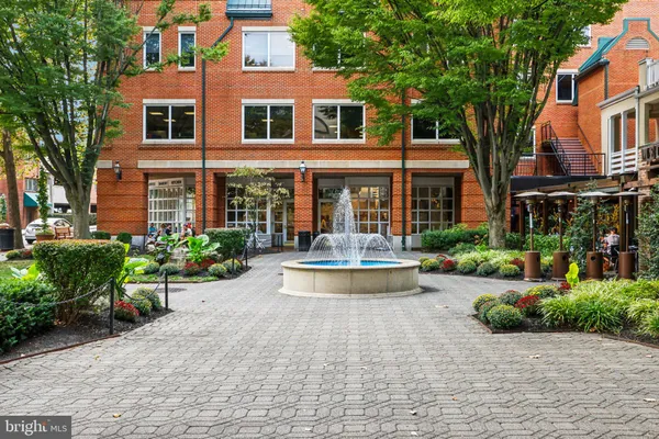 a view of a building with potted plants and a bench