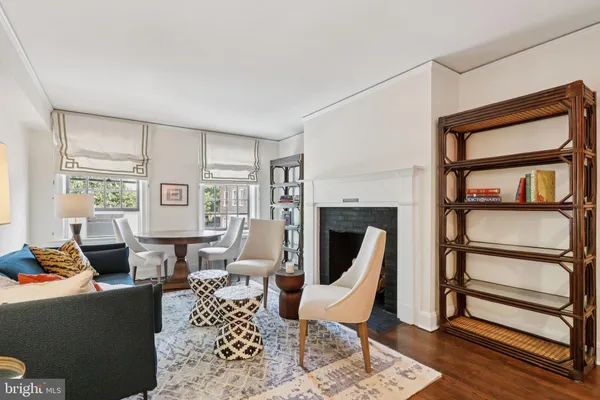 a living room with furniture a rug and a fireplace