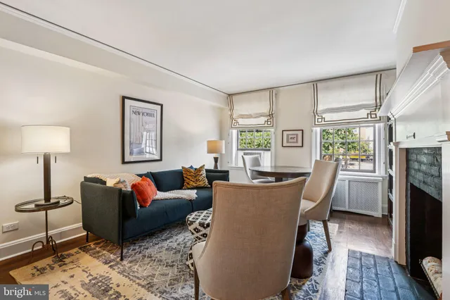 a living room with furniture a window and a flat screen tv