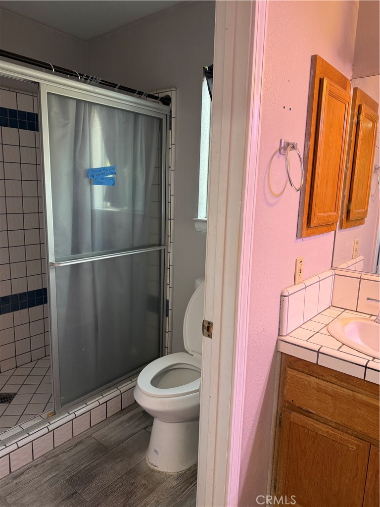 18602 Cocqui Road Apple Valley, CA 92307 - Photo 10 of 16 a bathroom with a toilet and a shower