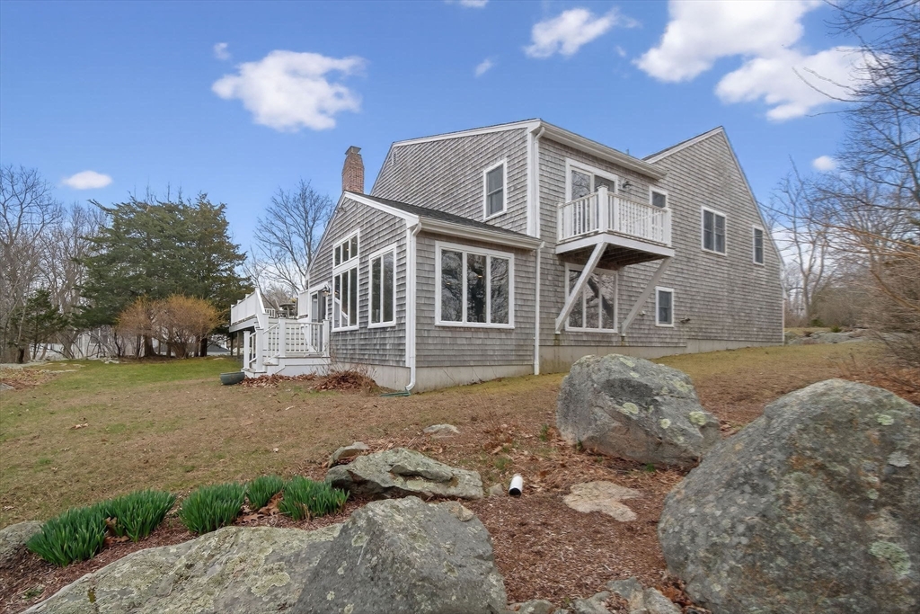 32 Howe Road Cohasset, MA 02025 - Photo 12 of 25 a front view of a house with a yard