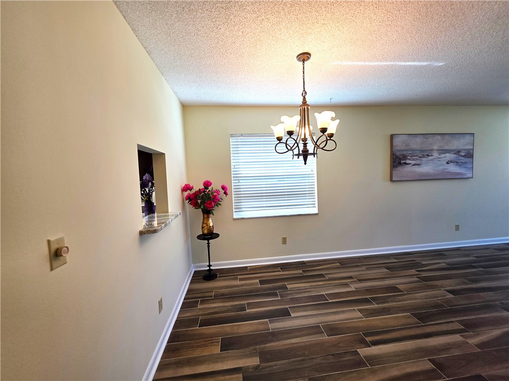88 Crooked Tree Lane, Unit 107 Vero Beach, FL 32962 - Photo 11 of 33 a view of entryway and hall with wooden floor