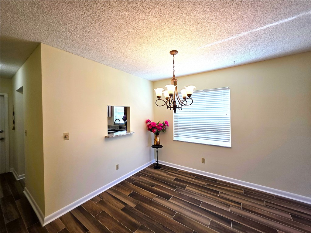 88 Crooked Tree Lane, Unit 107 Vero Beach, FL 32962 - Photo 12 of 33 a view of empty room with wooden floor